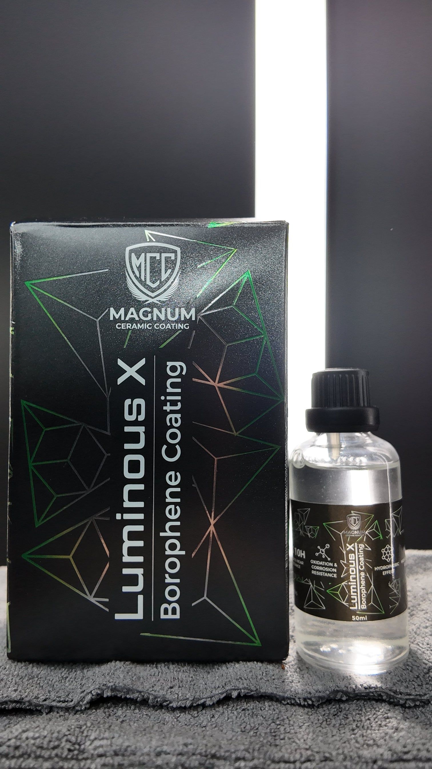 Black Luminous X Box and Glittery Dropper Bottle on a Gray Surface — Mobile Club Cars Cairns in Earlville, QLD