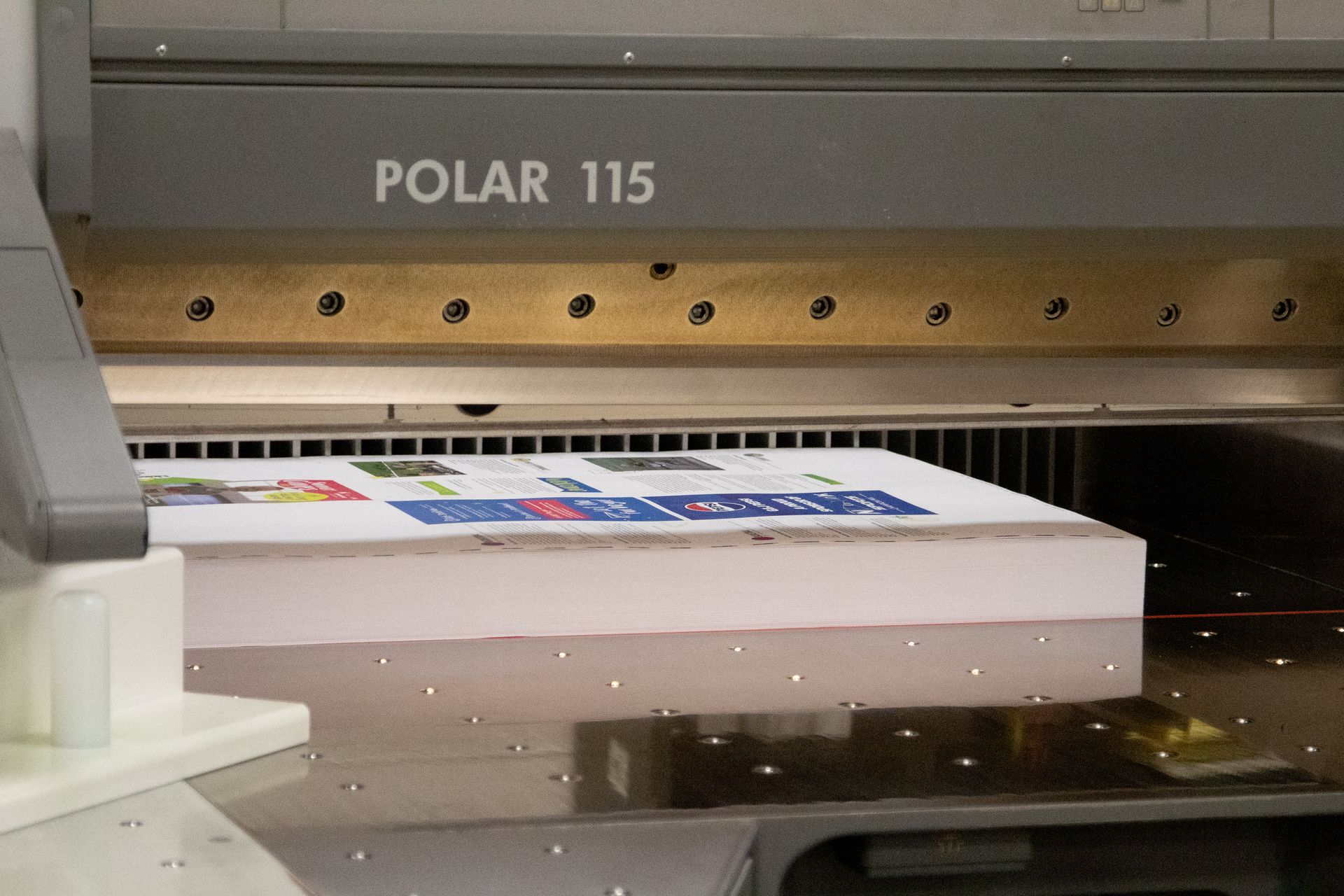 A polar 115 machine is printing a book