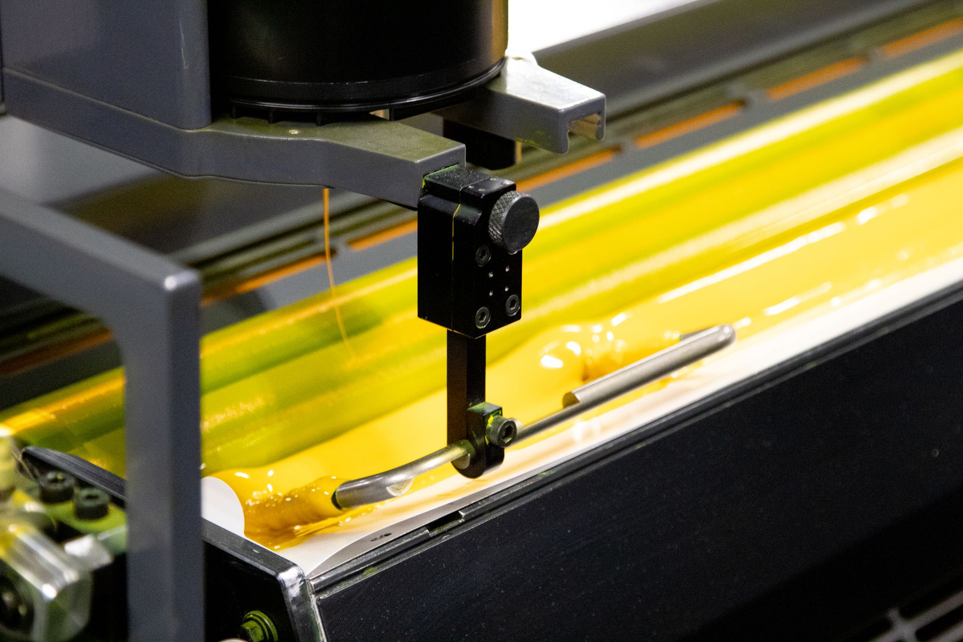 A machine with yellow liquid coming out of it