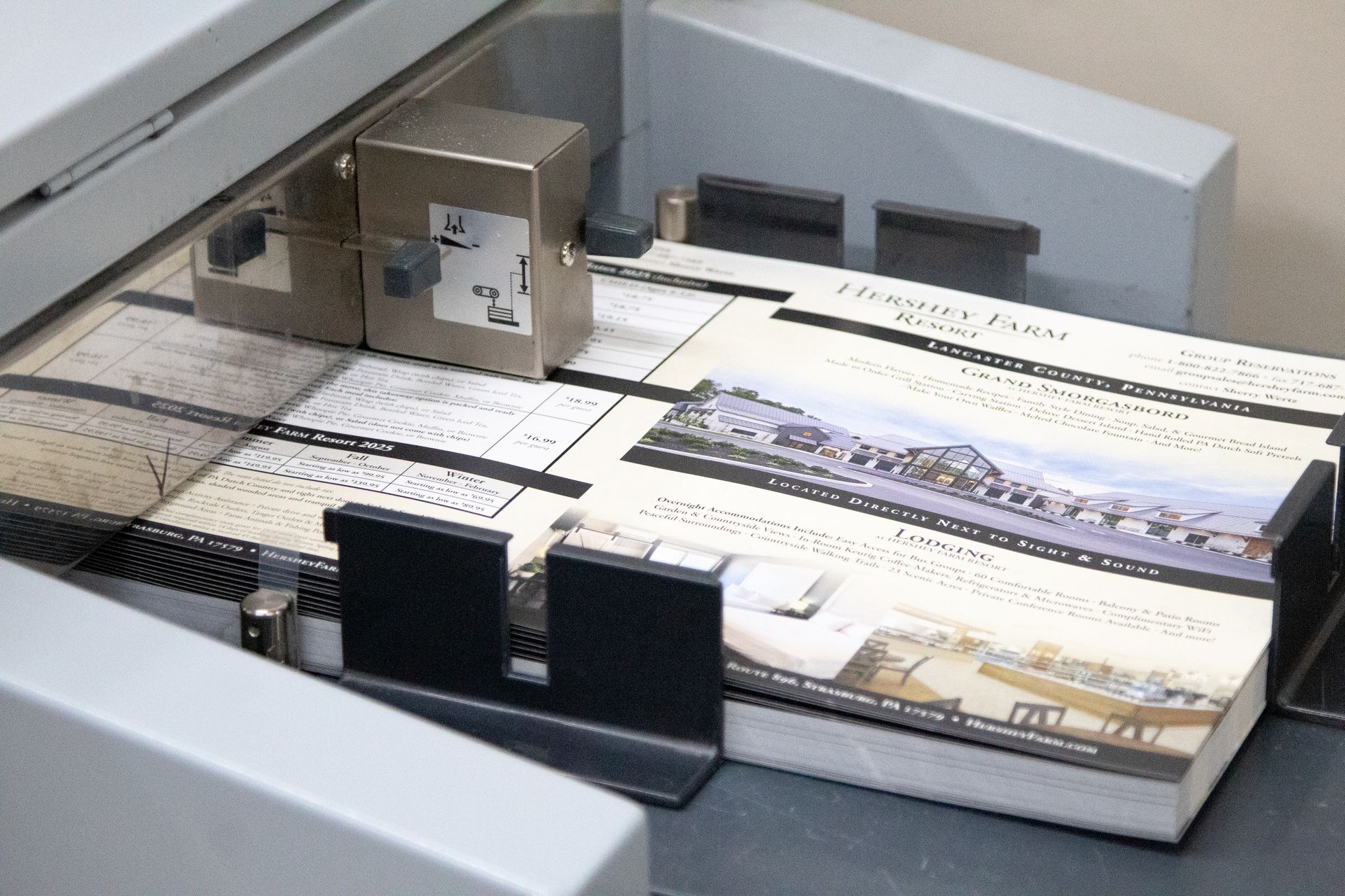 A stack of business cards are being printed on a machine