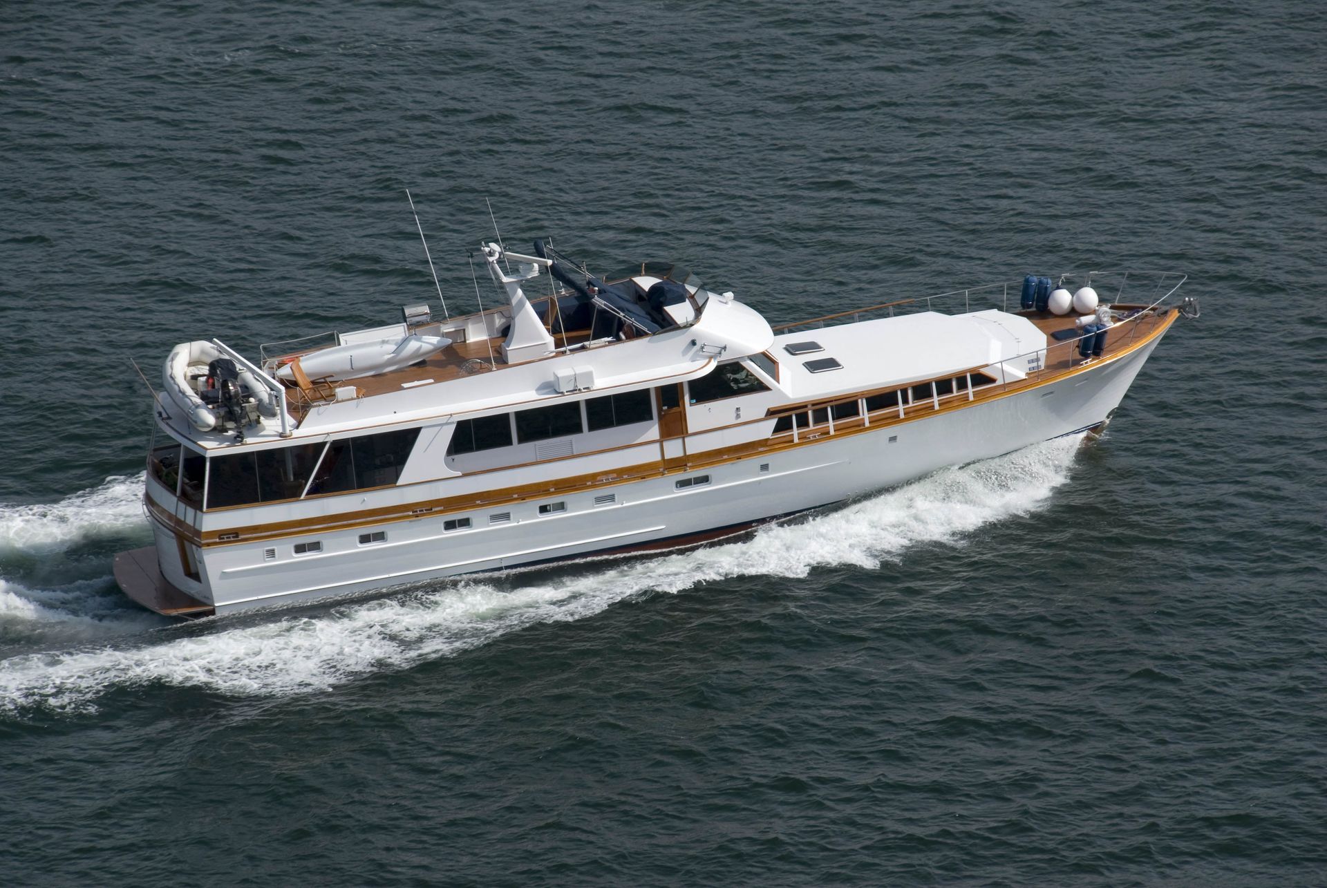 White and brown yacht moving on blue water.