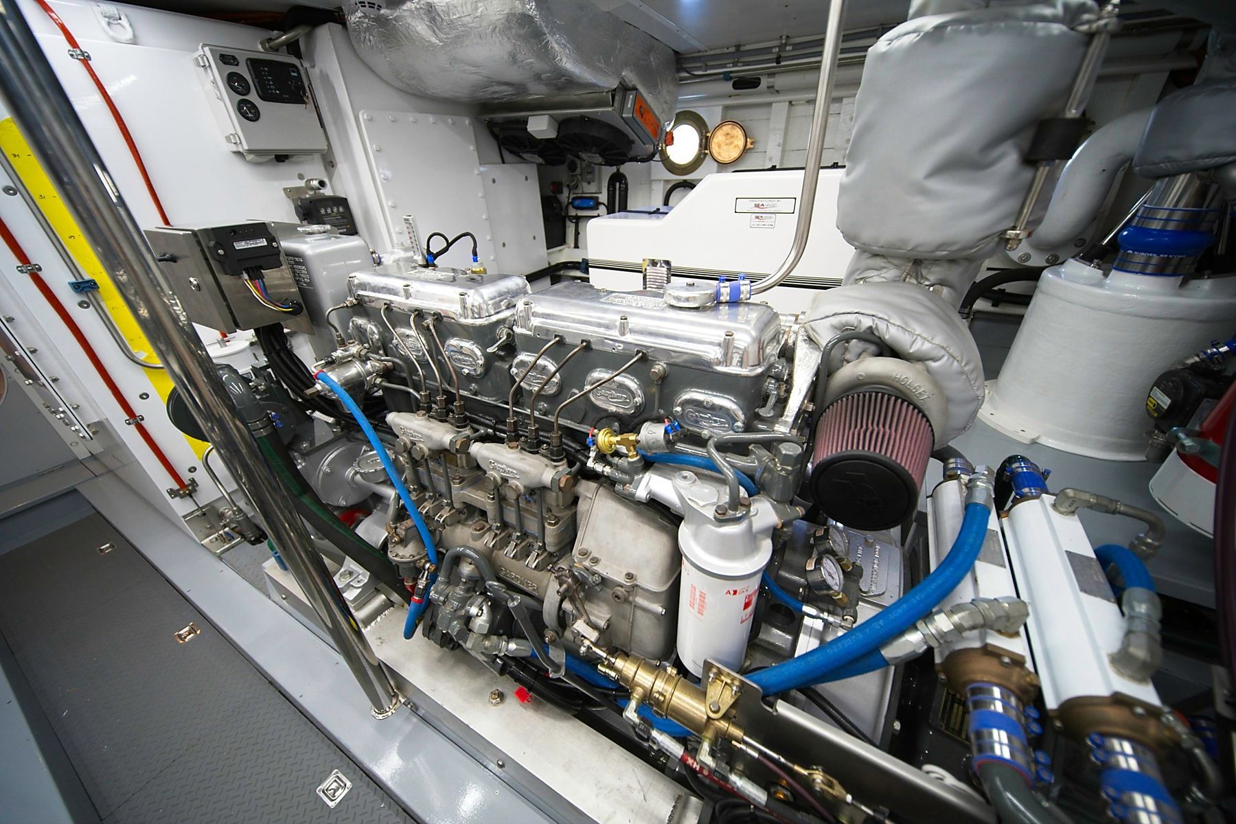 Pontoon boat docked on a lake with trees in the background. Sunny day.
