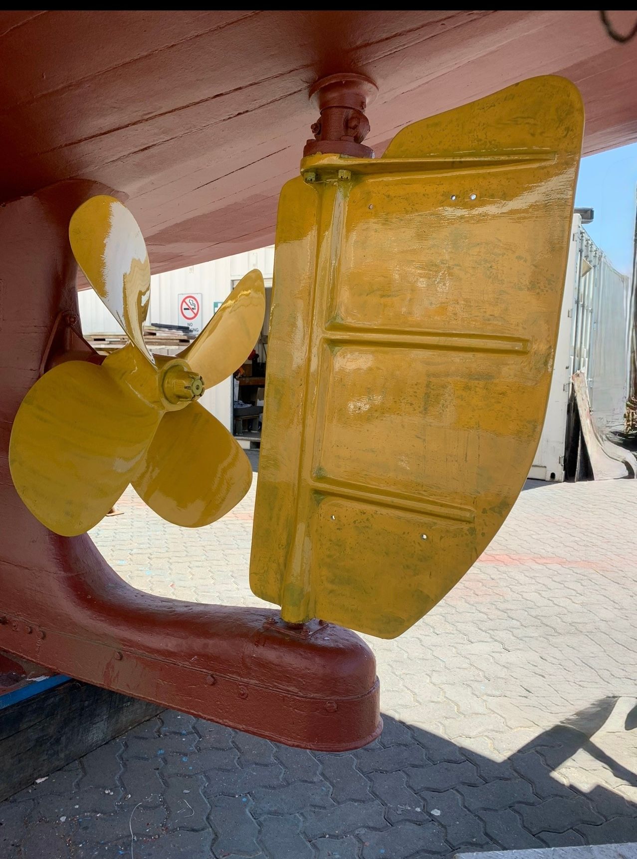 Undercarriage view of a vehicle's driveshaft, U-joint, and differential, showing mechanical components bolted together.