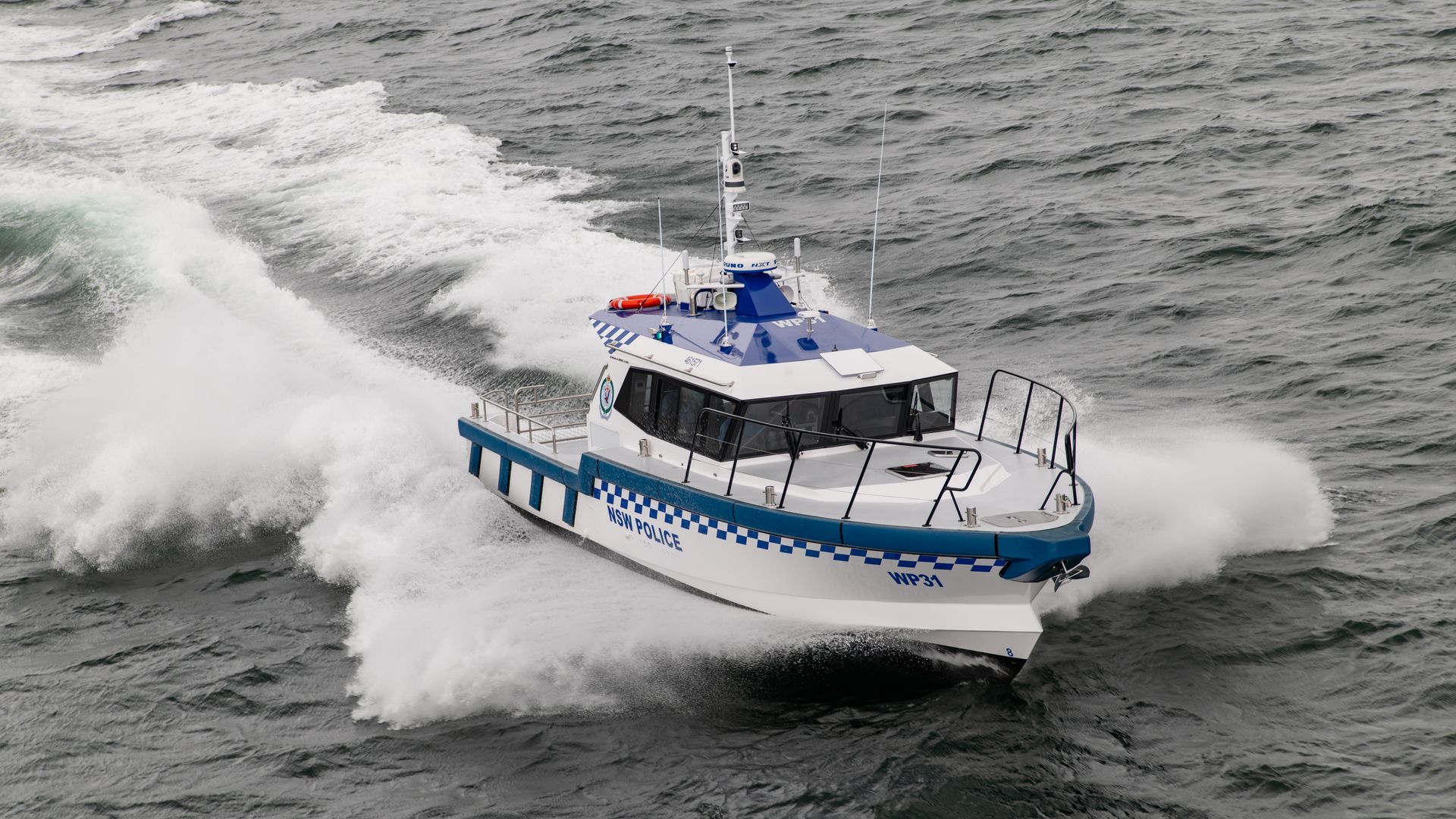 People on a white motorboat cruising on calm water.