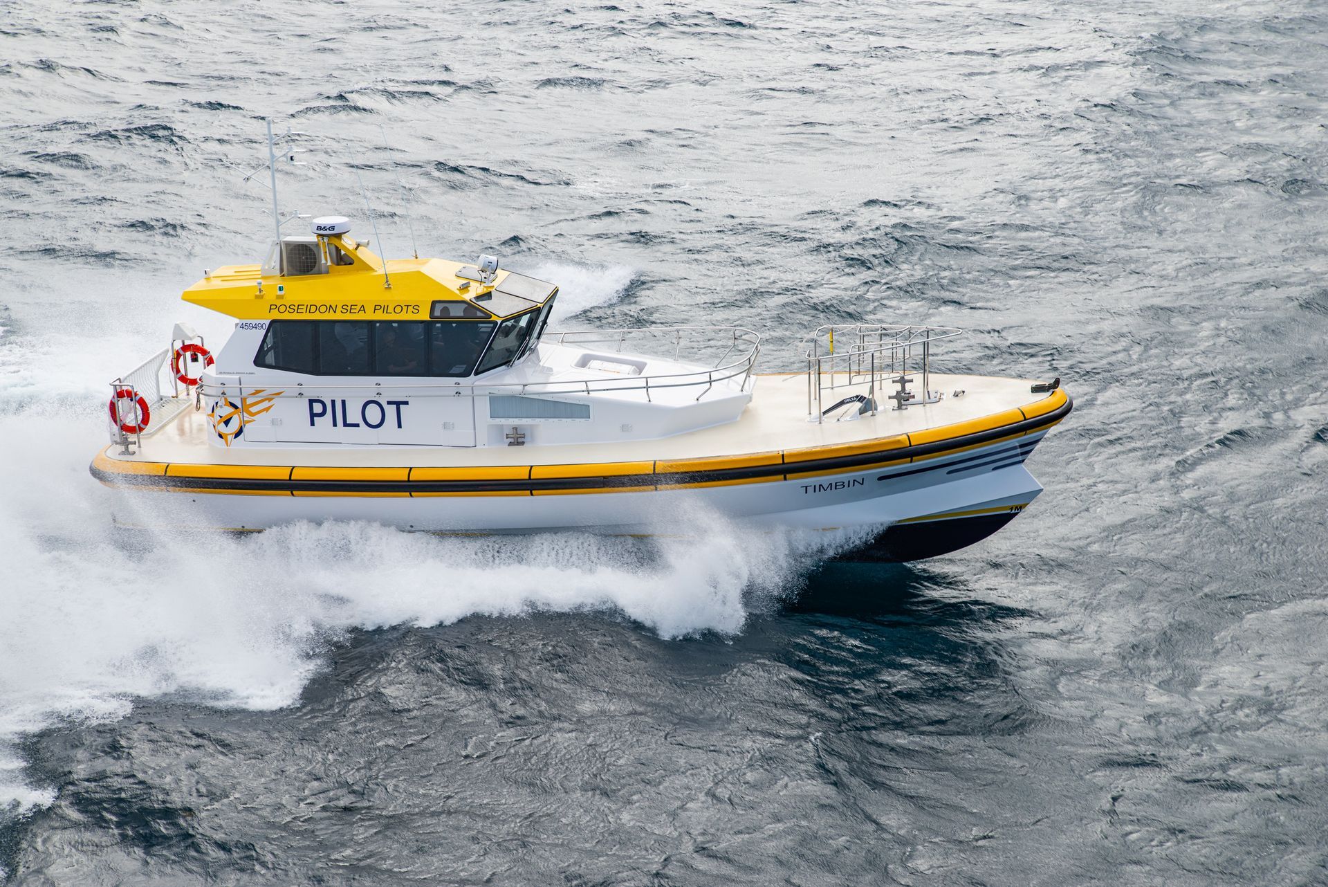 Fishing boat on blue ocean water, under a clear sky.