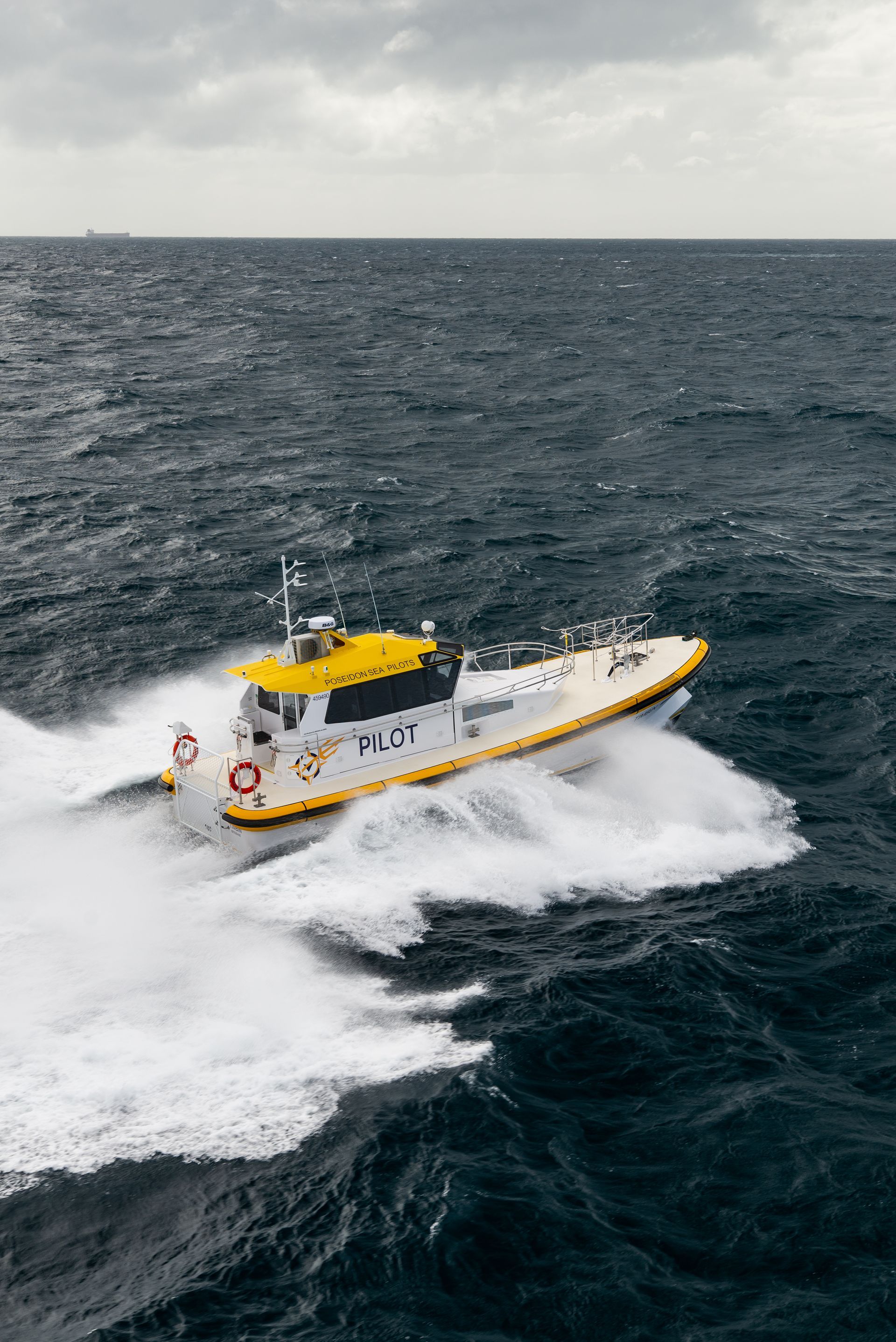 Fishing boat sailing on the ocean, surrounded by many birds under a bright sun.