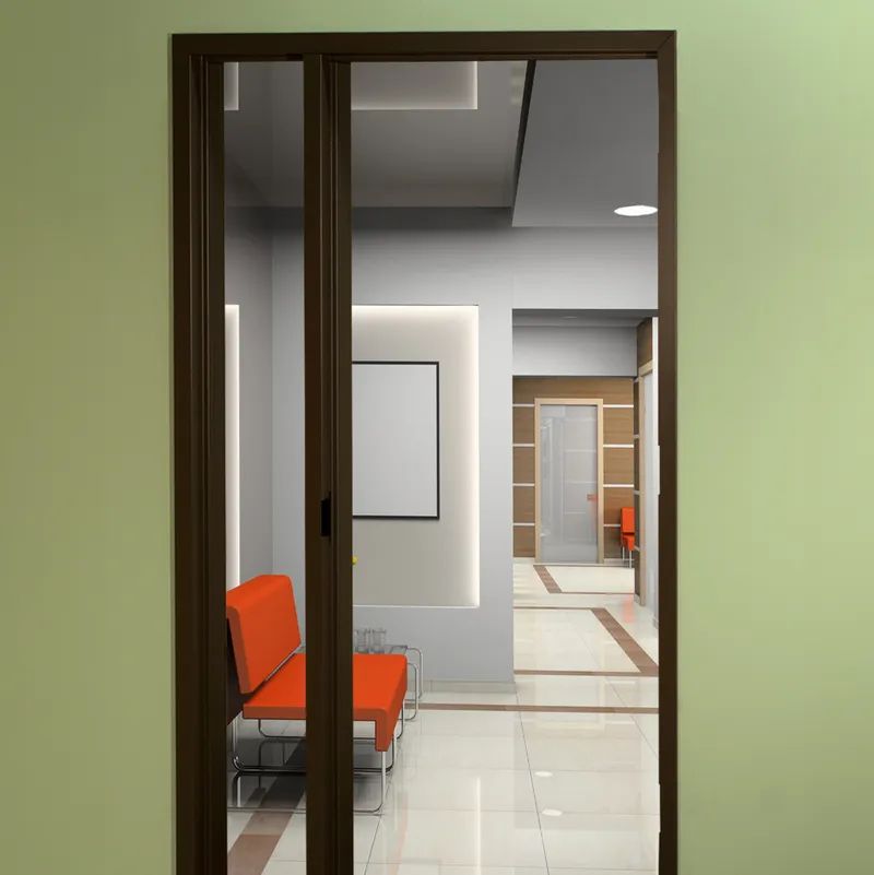 A black door is sitting in front of a gray wall.