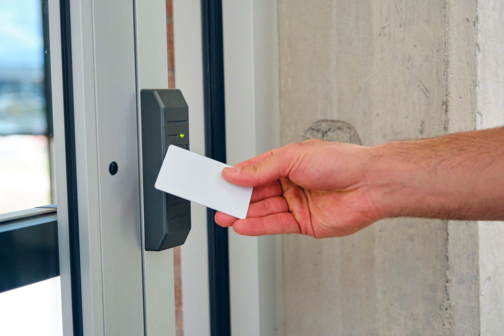 A person is inserting a card into a door lock.