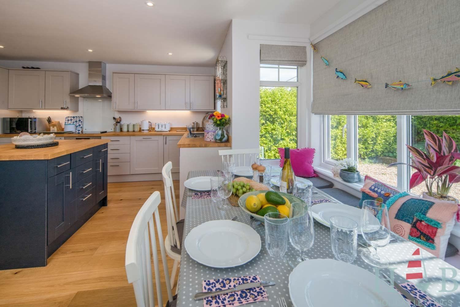 A kitchen and dining room with plates and glasses on the table