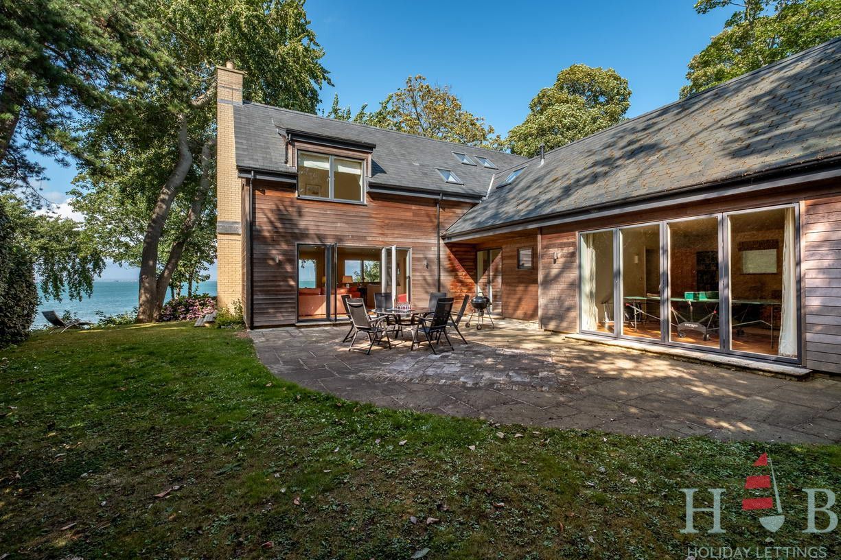 A large house with a lot of windows and a logo that says hb