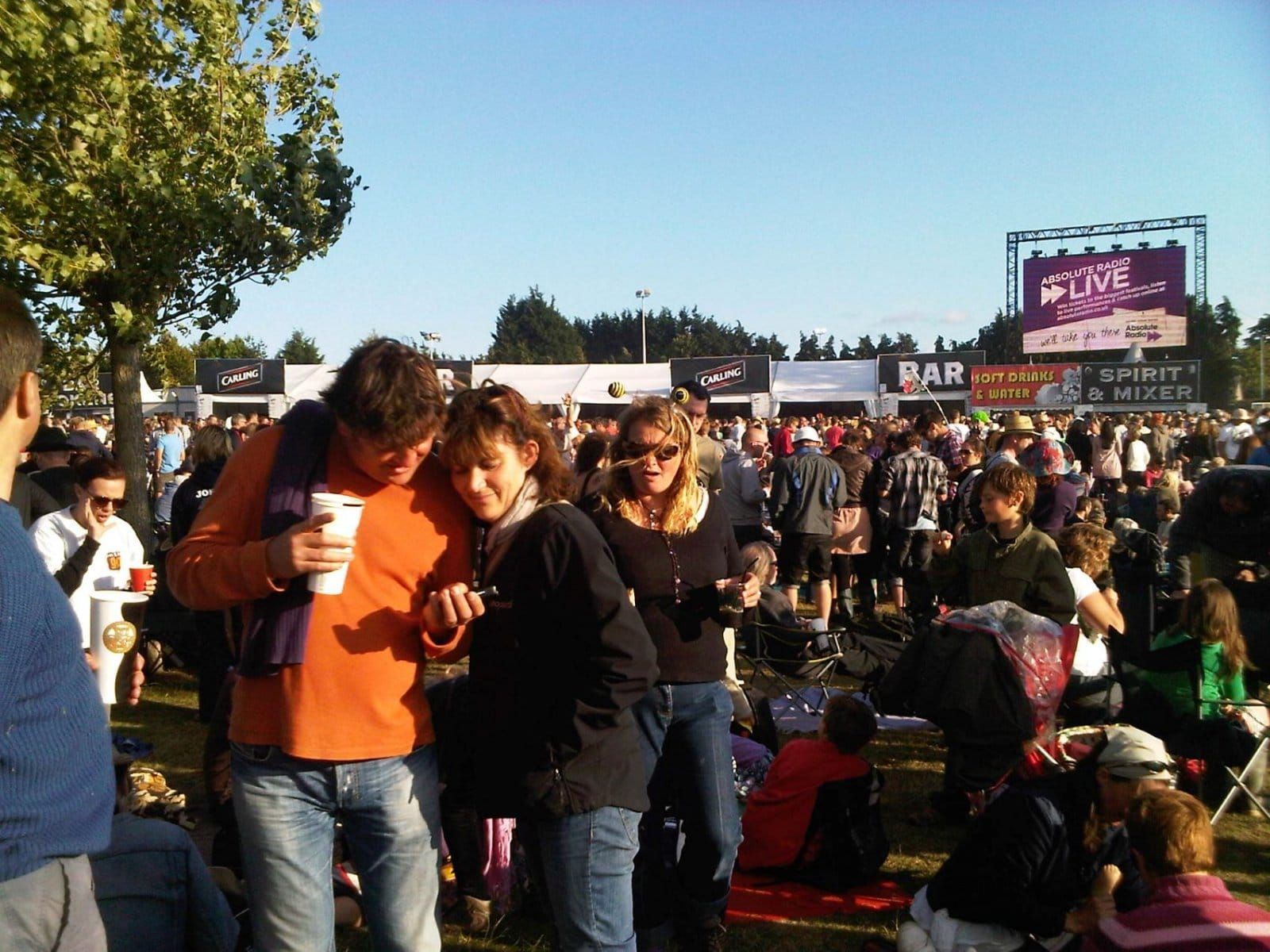 A crowd of people are gathered in front of a sign that says bar