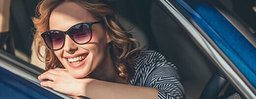 Smiling Woman inside a car — Automotive Repair in Kinston, NC
