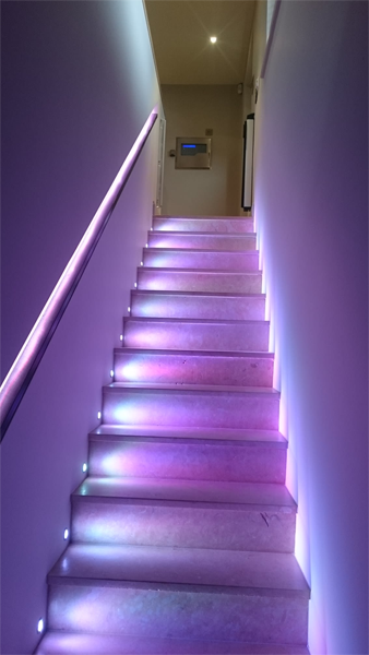 staircase with purple lighting