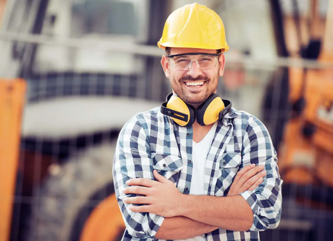 construction business owner smiles knowing he is covered by commercial insurance