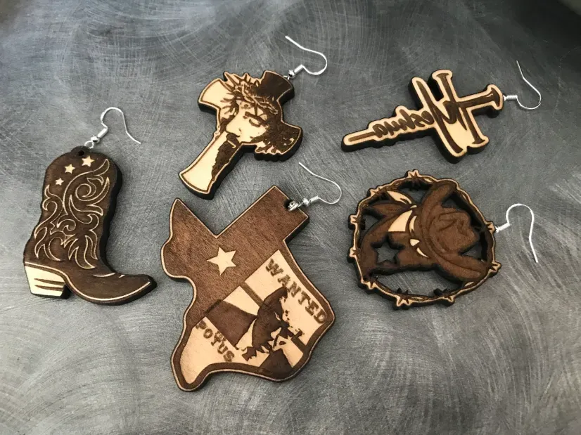 A group of wooden earrings are sitting on a table.