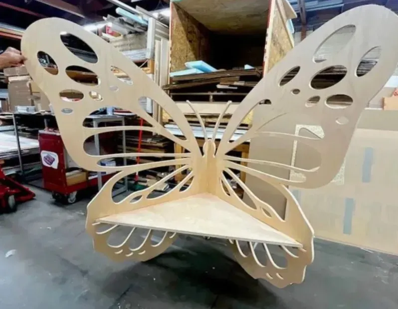 A wooden chair in the shape of a butterfly