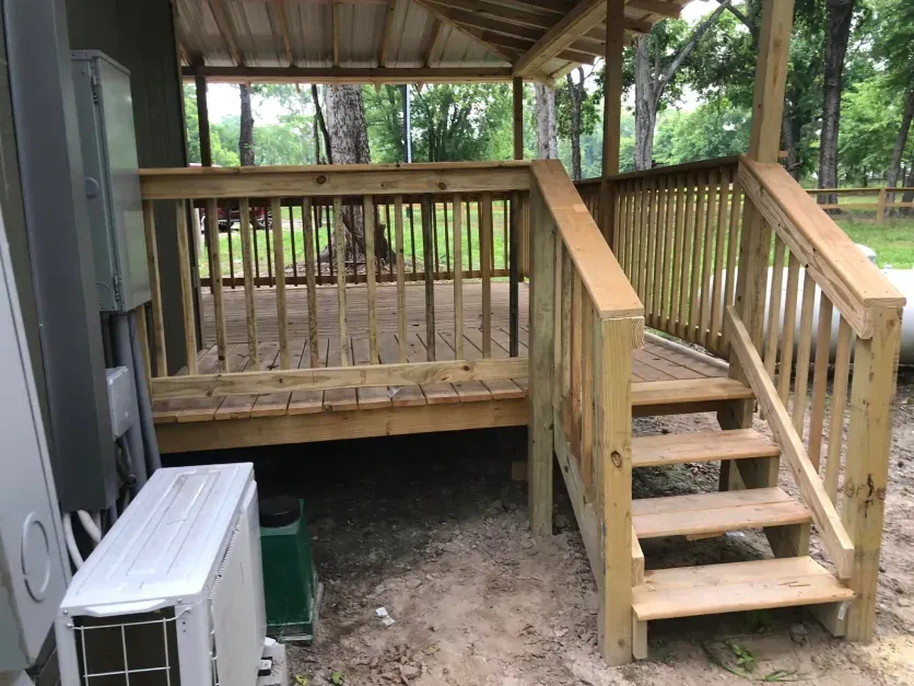 A wooden deck with stairs leading up to it