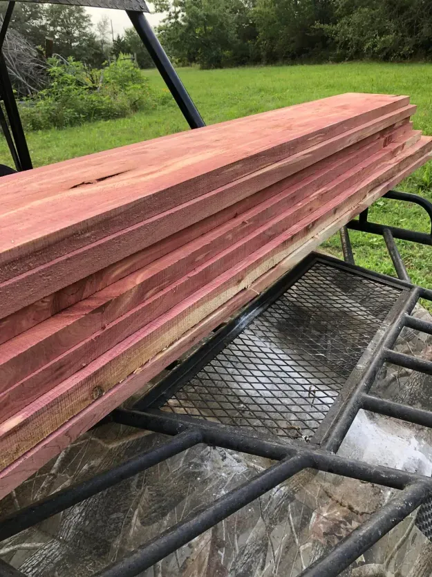 A stack of wood sitting on top of a metal table.