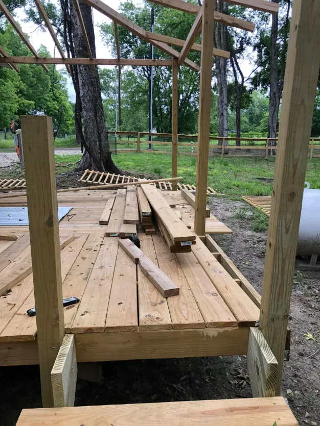 A wooden structure is being built in the woods