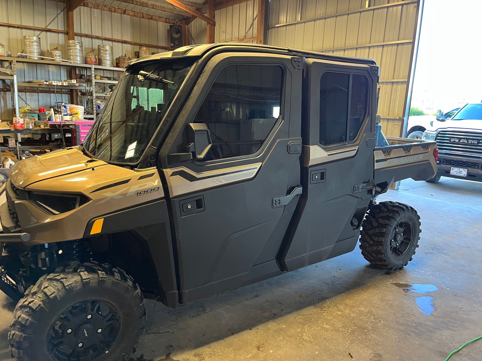 A polaris ranger crew 1000 is parked in a garage.