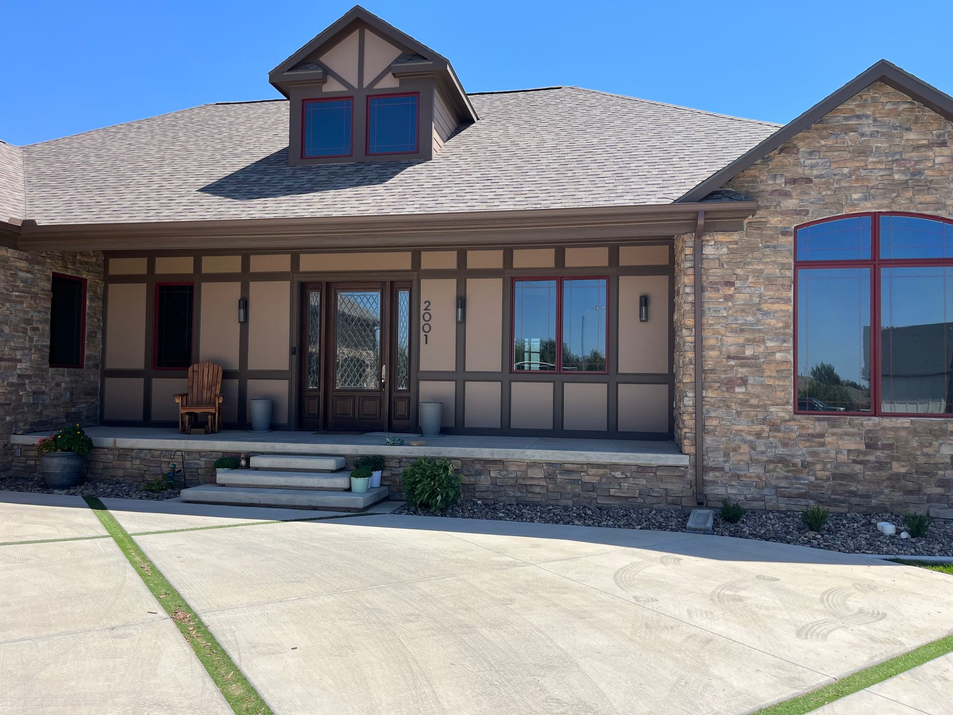 A large house with a lot of windows and a porch
