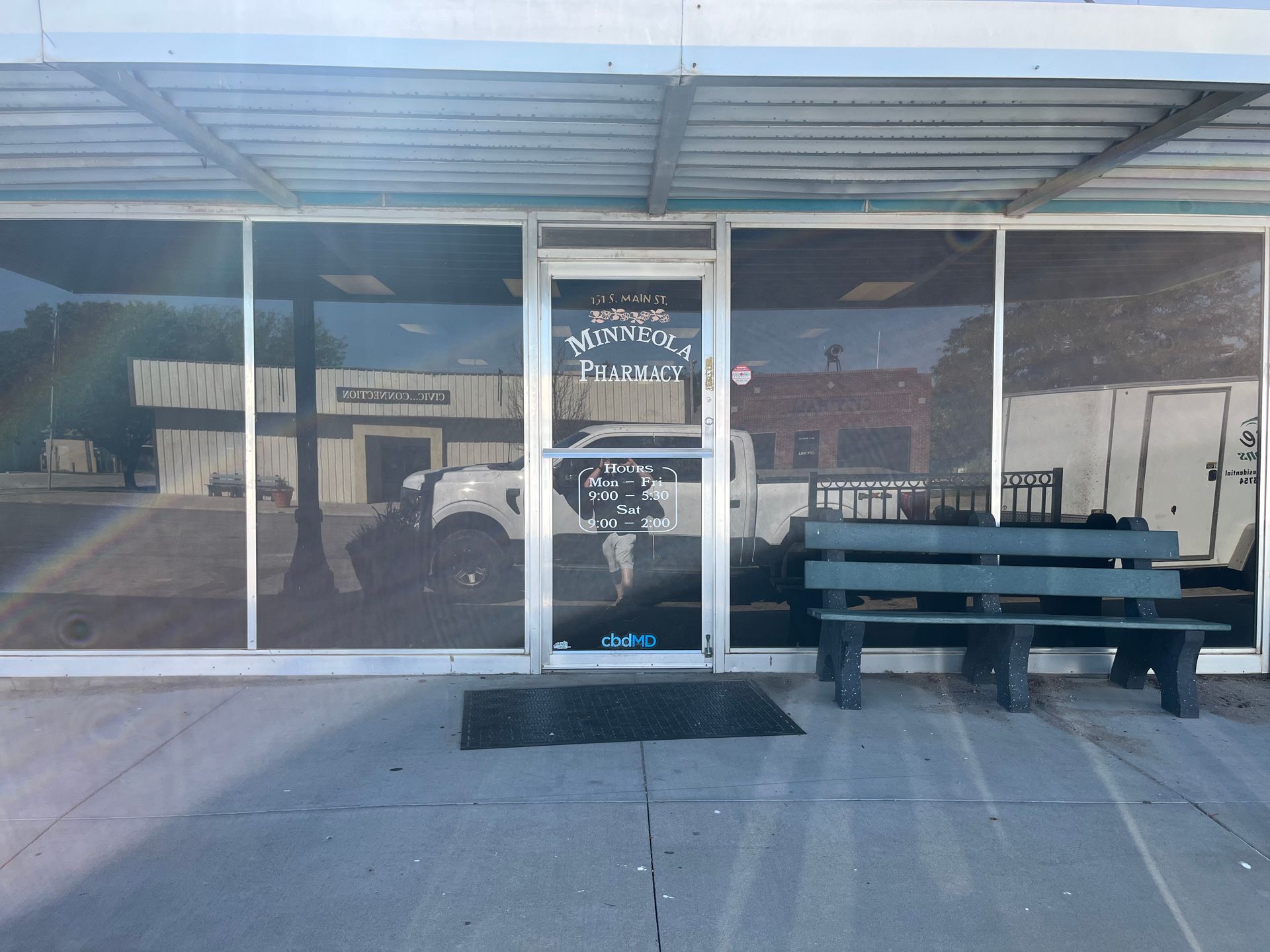 A white truck is parked in front of a glass door