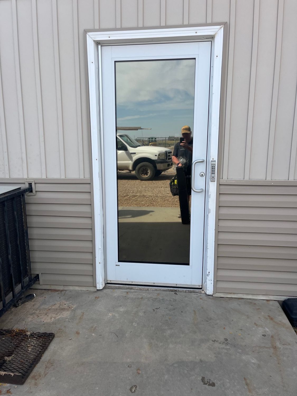 A white door with a reflection of a truck in it