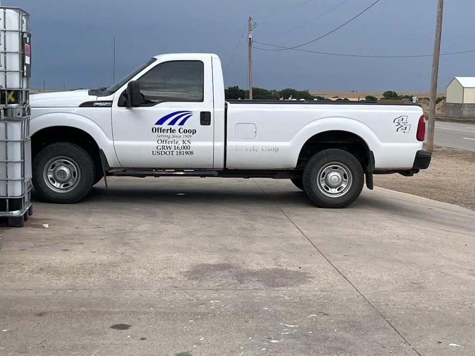 A white pickup truck is parked in a parking lot.