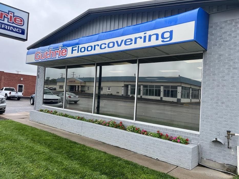 A building with a blue awning that says floorcovering on it