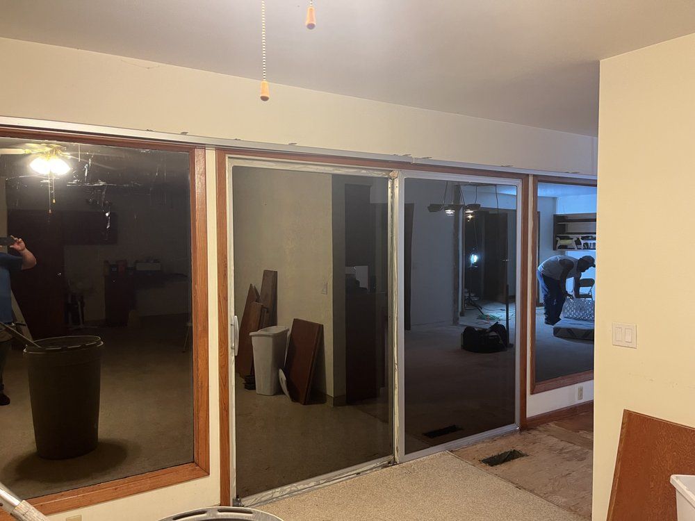 A room with a lot of windows and a sliding glass door.