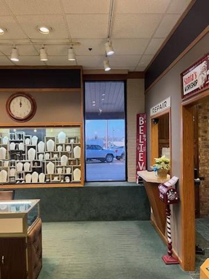 The inside of a jewelry store with a clock on the wall