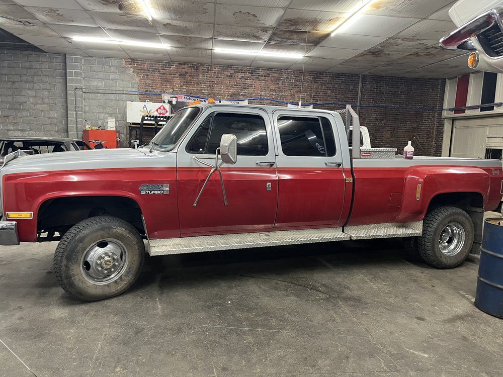 A red truck is parked in a garage.