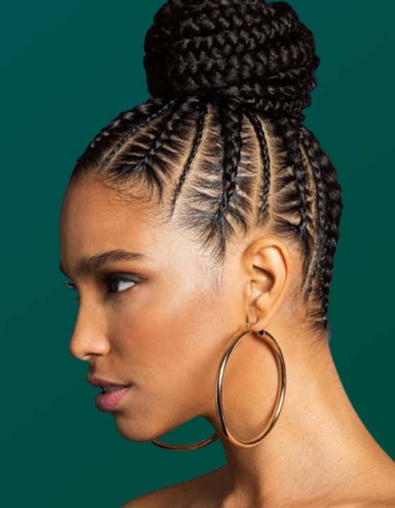 A woman with braids in a bun and hoop earrings.