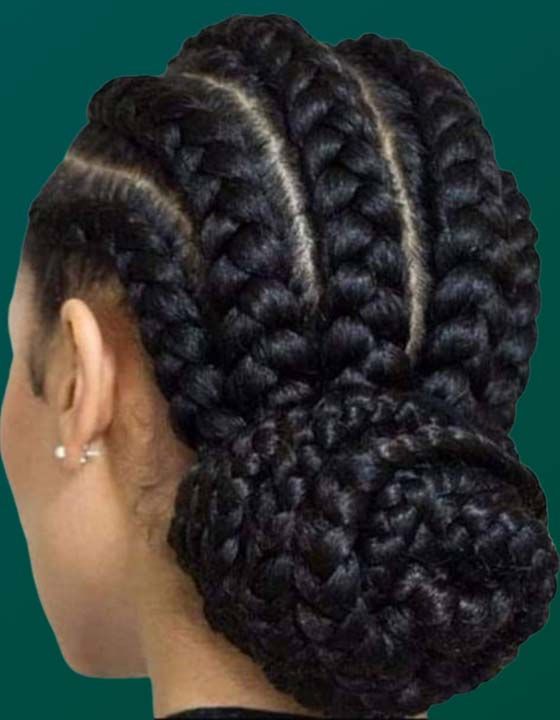 A woman with braids in a bun on her head.