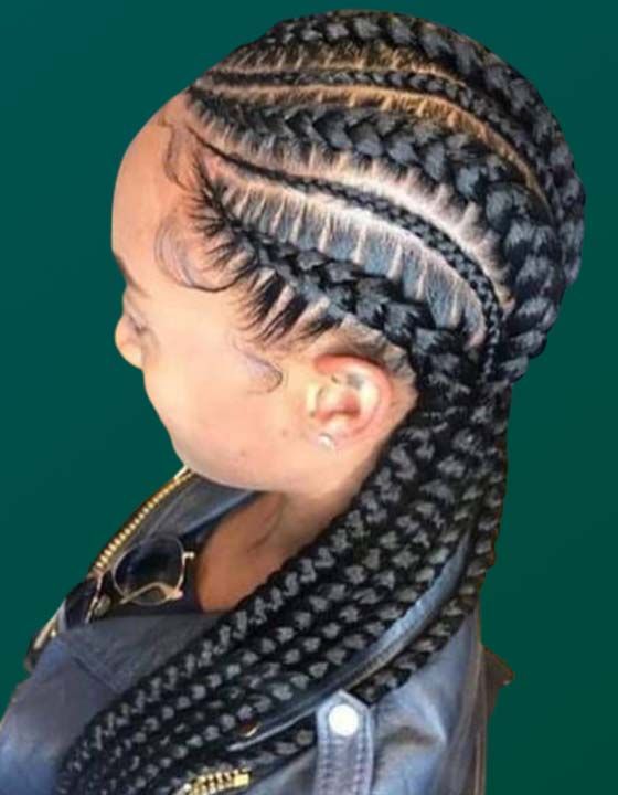 A woman with braids in her hair is wearing a leather jacket.