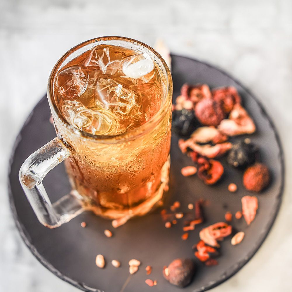 A large stand-up pouch and two smaller snack packets featuring red plum illustrations against a pale background.