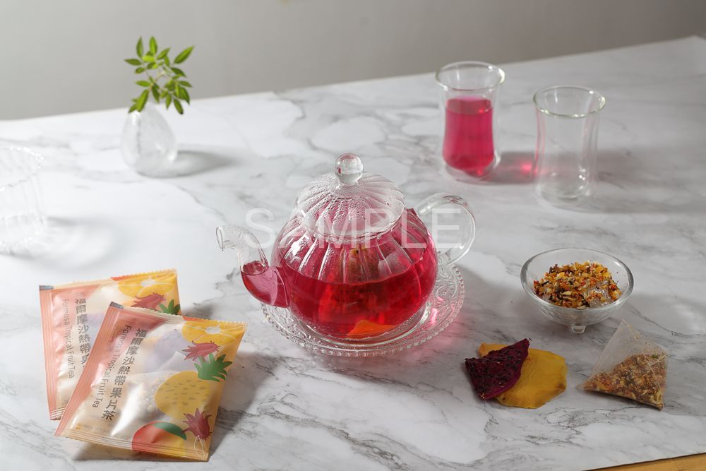 A top-down view of a speckled ceramic plate with a small bowl of fruit-infused water, dried fruit, and a garnish mix.