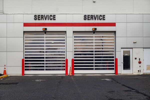 A service building with two garage doors and a sign that says service