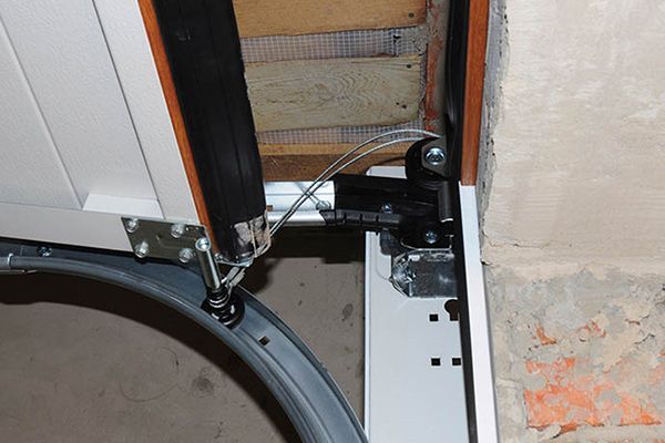A close up of a garage door with a chain attached to it.