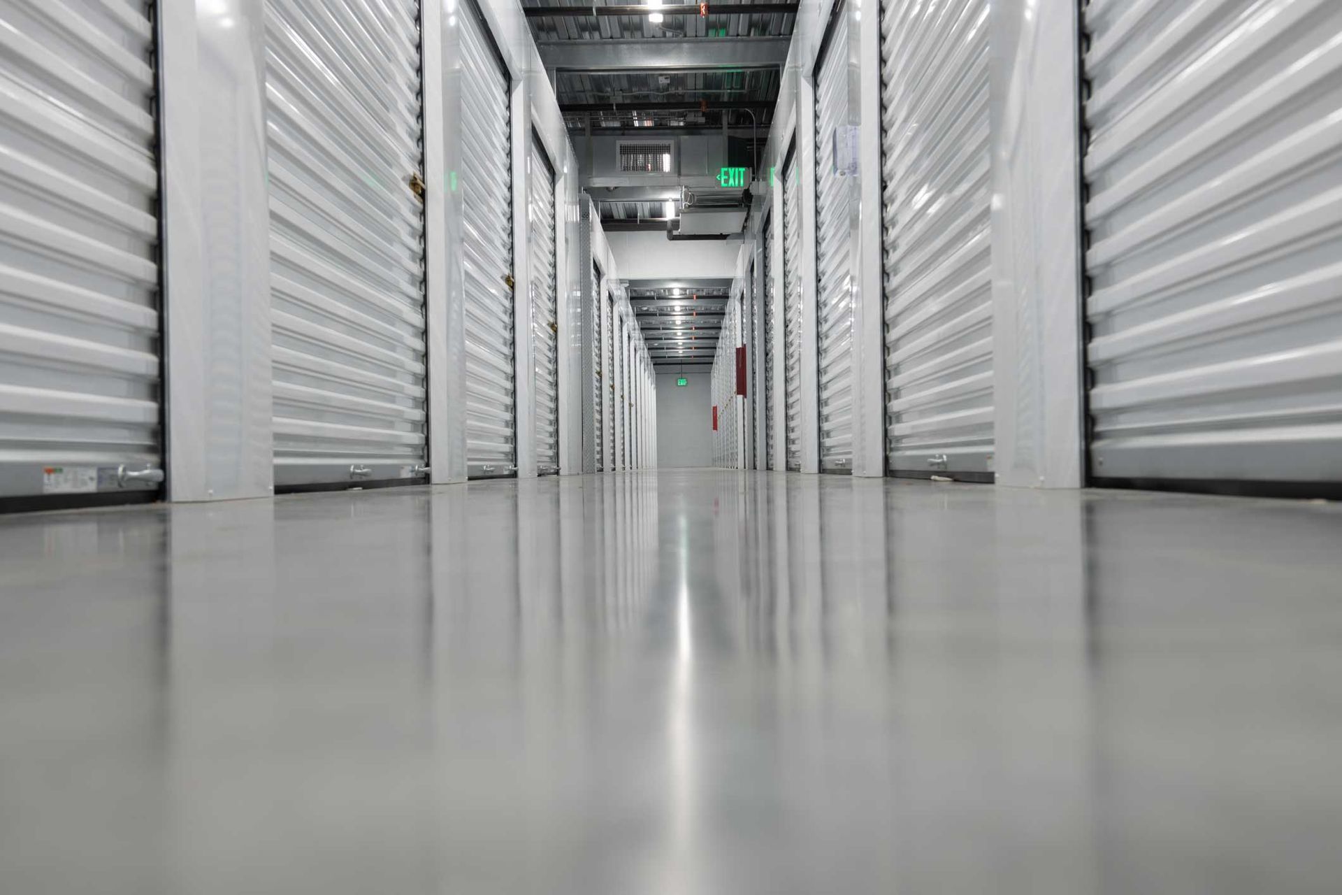 Climate-controlled units hallway with clean indoor storage doors and polished concrete floors. Climate-controlled units hallway with clean indoor storage doors and polished concrete floors.