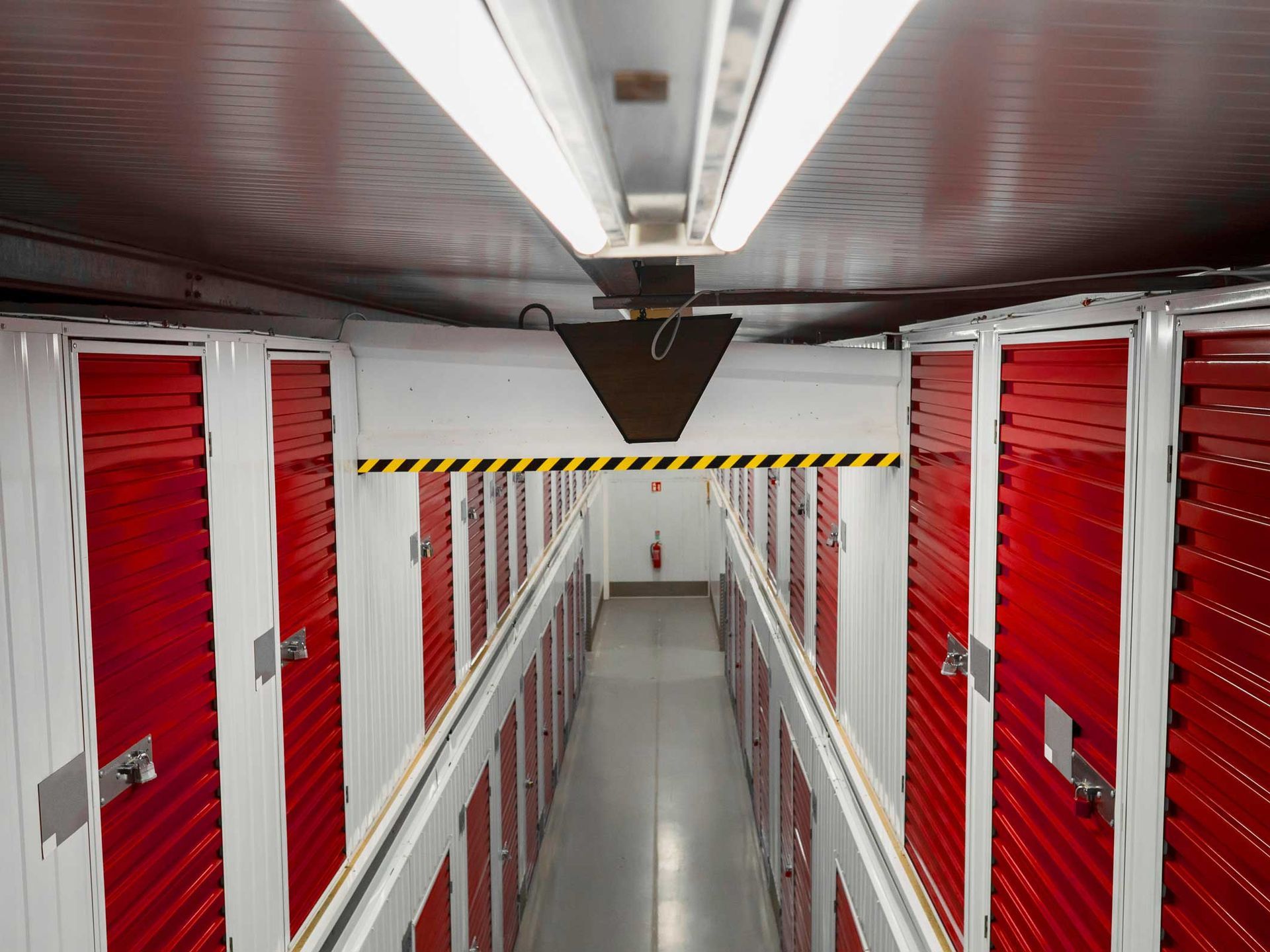 A series of red and white storage units showcasing uniformity and residential storage options.