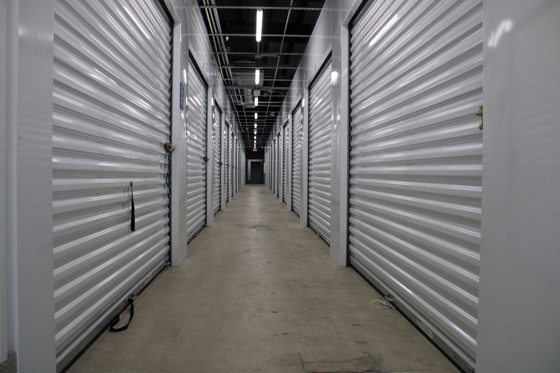 A long hallway filled with rows of empty storage units.