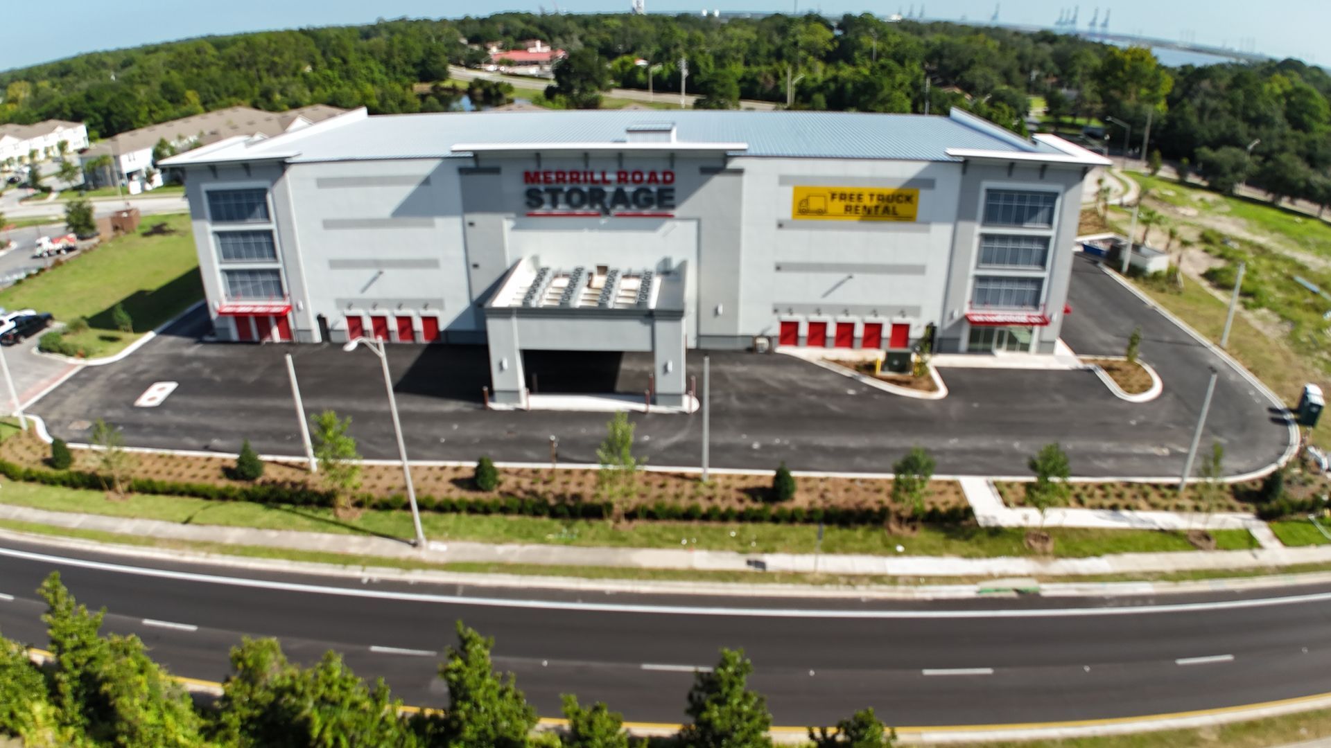 An aerial view of a storage building next to a road