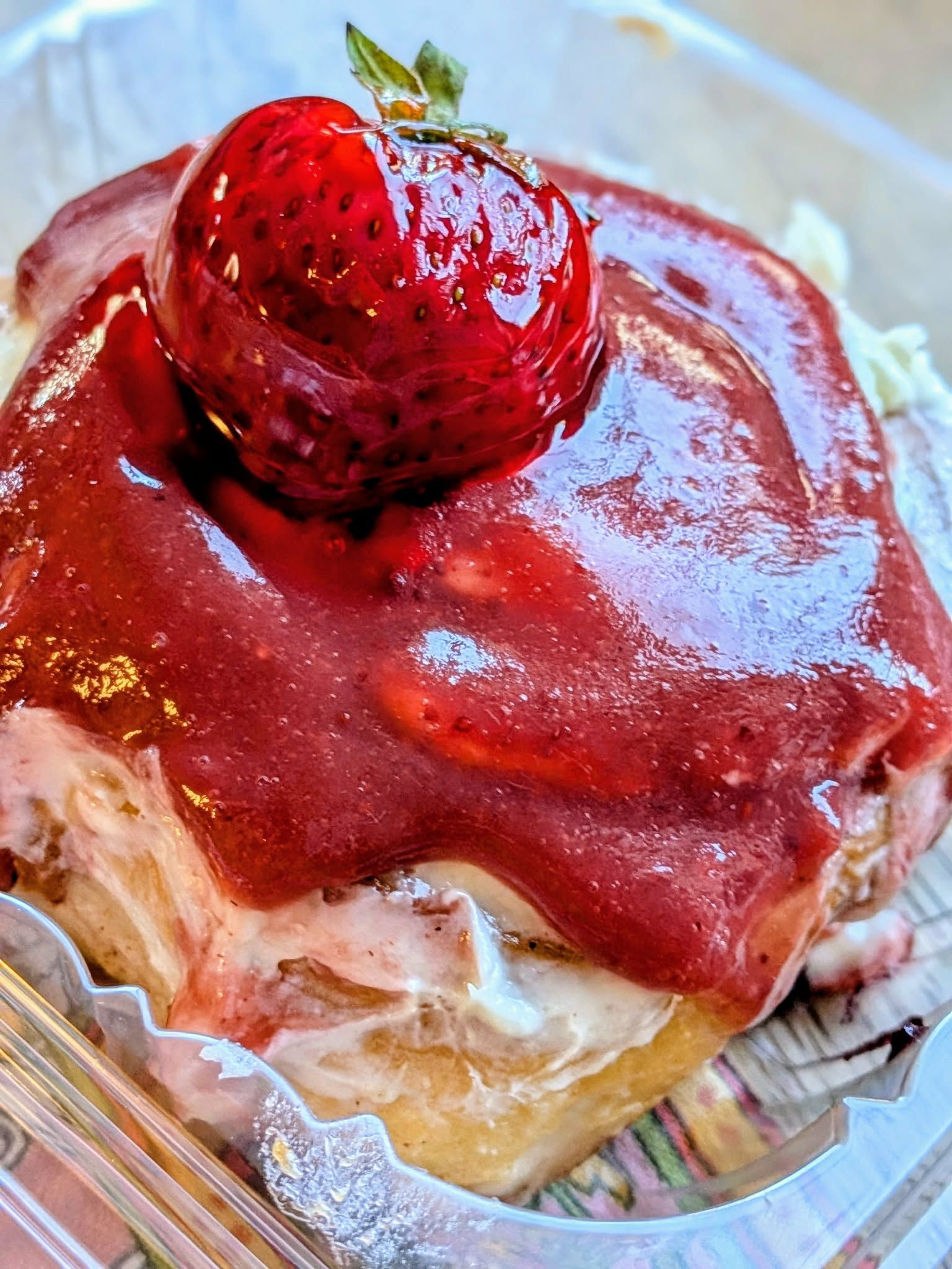 Strawberry pastry with red glaze and whole strawberry on top.
