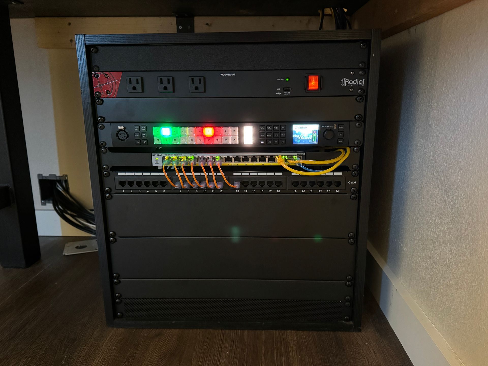 A black rack with a lot of electrical equipment on it