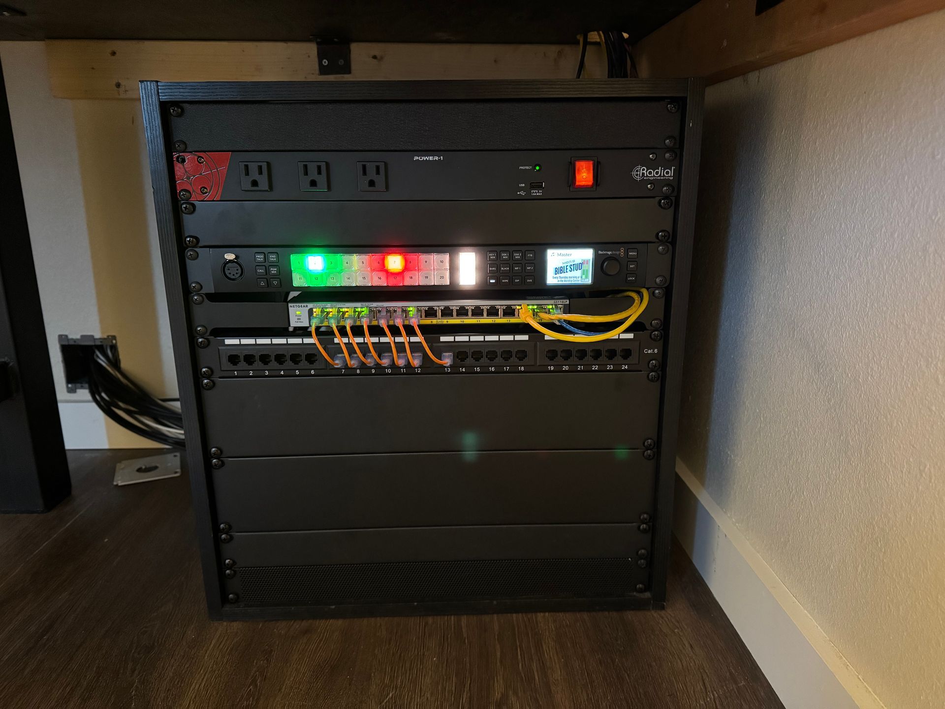 A black rack with a lot of electrical equipment on it