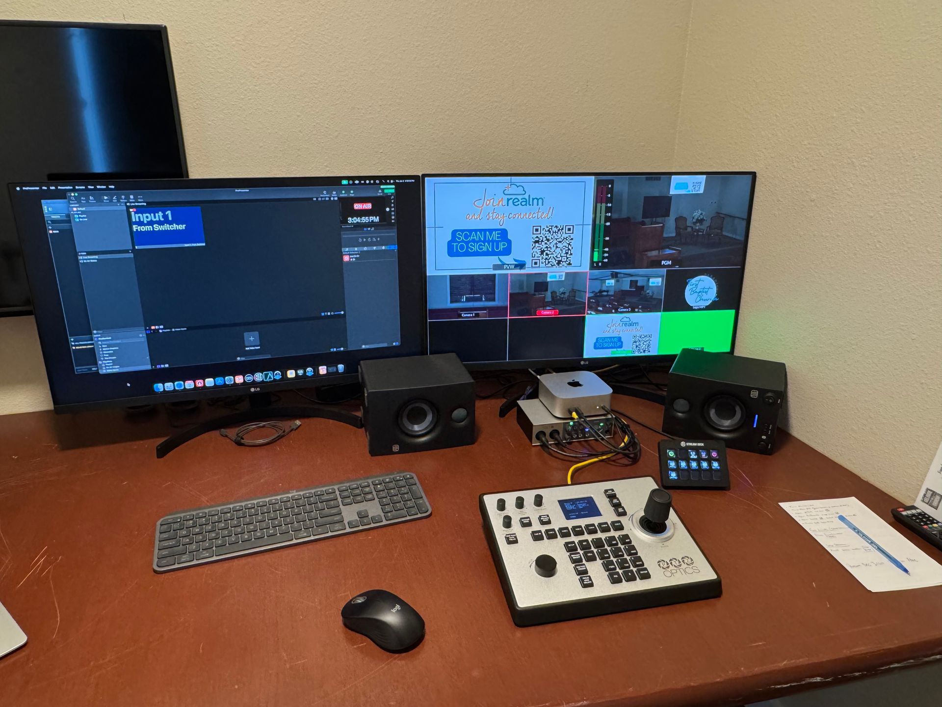A desk with two monitors , a keyboard and a mouse on it.