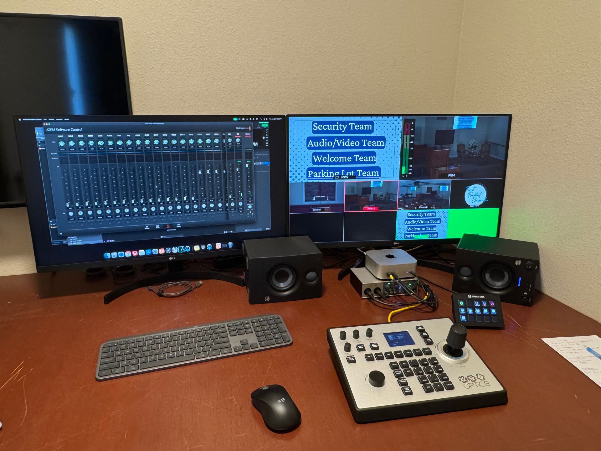 A desk with two monitors a keyboard and a mouse on it