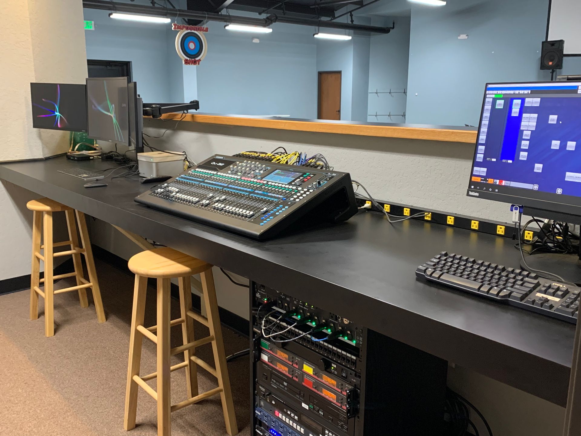 A desk with a computer and a mixer on it.