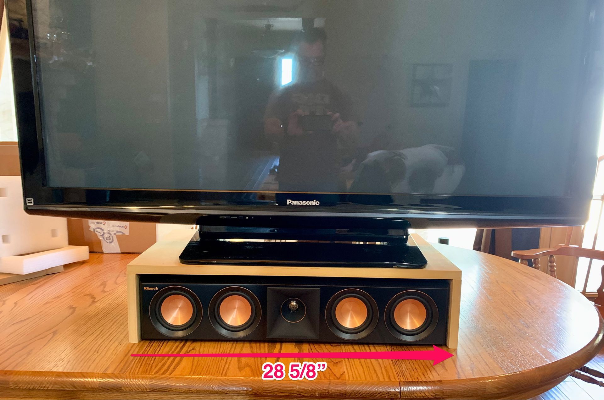 A flat screen tv is sitting on top of a wooden table.